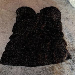 It is by Wet Seal. It is black with white sparkles all over.